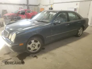 2000 Mercedes-Benz E-Class AWD with VIN WDBJF82G4YX027683, listed as a Copart auction lot 77146524 with 228,654 mi miles and Clean Title. Bid and sale history available at carsss.com. Image 1.