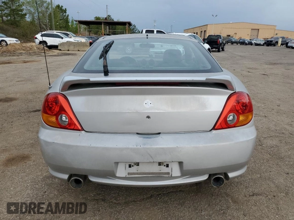 2003 Hyundai Tiburon GT z VIN KMHHN65F13U013420, wystawiony jako Copart lot #51234495 z przebiegiem 230 612 mil mil oraz Szkoda całkowita • Salvage title. Historia ofert i sprzedaży dostępna na DreamBid. Obrazek 6.