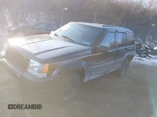 1996 Jeep Grand Cherokee Laredo with VIN 1J4GZ58S3TC197587, listed as a IAAI auction lot 41423318 with 200,116 mi miles. Bid and sale history available at carsss.com. Image 2.