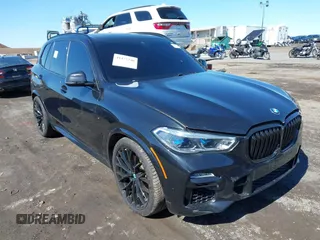 2019 BMW X5 xDrive50i with VIN 5UXJU2C5XKLN66873, listed as a IAAI auction lot 41472246 with 98,571 mi miles. Bid and sale history available at carsss.com. Image 1.