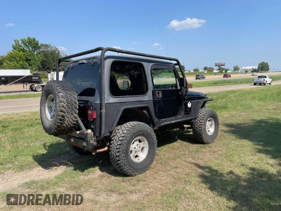 1999 Jeep Wrangler Sahara with VIN 1J4FY49S5XP496486, listed as a Copart auction lot 77263014 with 128,498 mi miles and Clean Title. Bid and sale history available at carsss.com. Image 4.