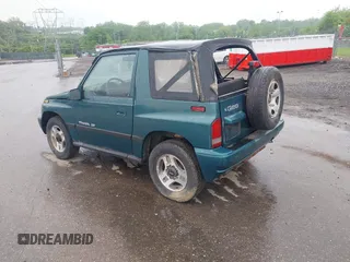 1996 Chevrolet Tracker z VIN 2CNBJ1860T6910906, wystawiony jako IAAI lot #42257309 z przebiegiem 206 888 mil mil oraz . Historia ofert i sprzedaży dostępna na DreamBid. Obrazek 3.