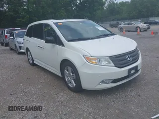 2013 Honda Odyssey Touring with VIN 5FNRL5H9XDB049390, listed as a IAAI auction lot 42532861 with 129,376 mi miles and . Bid and sale history available at DreamBid. Image 1.