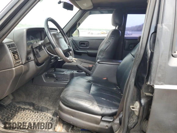 1999 Jeep Cherokee Sport with VIN 1J4FF68S9XL635836, listed as a Copart auction lot 59573195 with 187,035 mi miles and Salvage title. Bid and sale history available at DreamBid. Image 7.