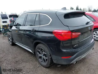 2018 BMW X1 xDrive28i with VIN WBXHT3C39J3H30531, listed as a IAAI auction lot 41890734 with 59,147 mi miles. Bid and sale history available at carsss.com. Image 3.