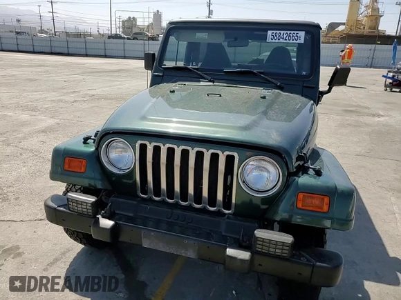 2000 Jeep Wrangler Sahara z VIN 1J4FA59S1YP746043, wystawiony jako Copart lot #58842665 z przebiegiem 148 348 mil mil oraz Szkoda całkowita • Salvage title. Historia ofert i sprzedaży dostępna na DreamBid. Obrazek 13.