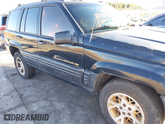 1998 Jeep Grand Cherokee Limited with VIN 1J4GX78Y8WC110325, listed as a IAAI auction lot 41357373 with 165,106 mi miles. Bid and sale history available at carsss.com. Image 6.