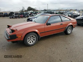 1983 Toyota Supra z VIN JT2MA67L9D0056034, wystawiony jako Copart lot #82382484 z przebiegiem 39 338 mil mil oraz Szkoda całkowita • Salvage title. Historia ofert i sprzedaży dostępna na DreamBid. Obrazek 1.