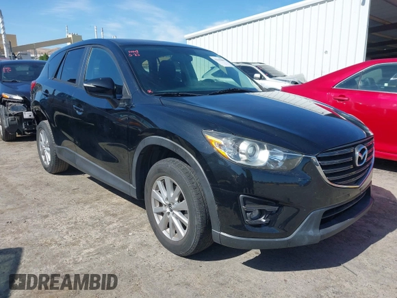 2016 Mazda CX-5 Touring z VIN JM3KE4CY2G0656270, wystawiony jako IAAI lot #42344489 z przebiegiem 60 449 mil mil oraz . Historia ofert i sprzedaży dostępna na DreamBid. Obrazek 1.