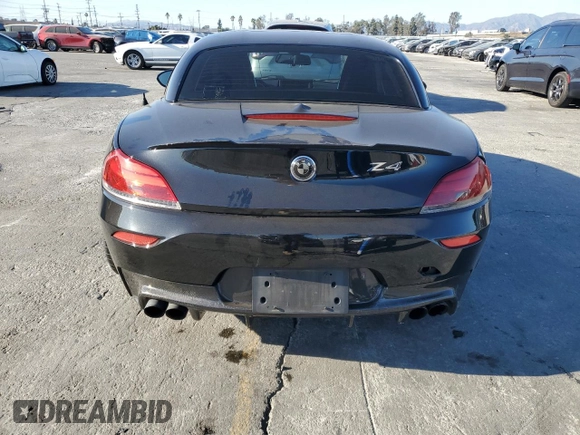 2011 BMW Z4 sDrive35is with VIN WBALM1C58BE393909, listed as a Copart auction lot 89218305 with 112,502 mi miles and Salvage title. Bid and sale history available at DreamBid. Image 6.