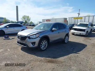 2014 Mazda CX-5 Grand Touring with VIN JM3KE4DY7E0311893, listed as a IAAI auction lot 42090872 with 102,154 mi miles and . Bid and sale history available at DreamBid. Image 2.