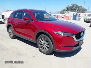 2021 Mazda CX-5 Grand Touring with VIN JM3KFADM5M0470483, listed as a IAAI auction lot 42785031 with 30,749 mi miles and . Bid and sale history available at DreamBid. Image 1.