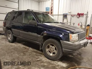 1997 Jeep Grand Cherokee Laredo with VIN 1J4GZ58S8VC675487, listed as a IAAI auction lot 41034046 with 243,284 mi miles. Bid and sale history available at carsss.com. Image 1.