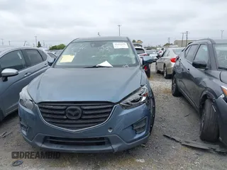 2016 Mazda CX-5 Touring z VIN JM3KE2CY2G0699138, wystawiony jako IAAI lot #42153228 z przebiegiem 144 191 mil mil oraz . Historia ofert i sprzedaży dostępna na DreamBid. Obrazek 12.