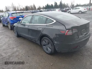 2019 Tesla Model 3 Mid Range with VIN 5YJ3E1EAXKF296378, listed as a IAAI auction lot 41739616 with 77,100 mi miles and . Bid and sale history available at DreamBid. Image 3.