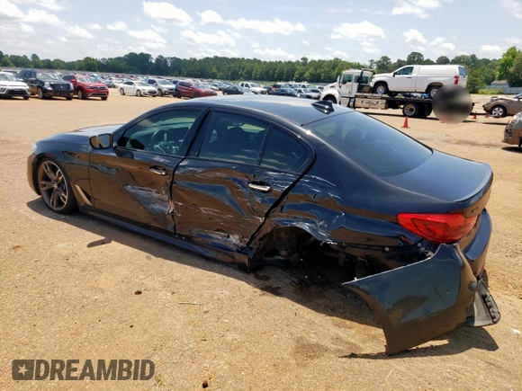 2018 BMW 5 Series M550i xDrive with VIN WBAJB9C54JB286450, listed as a Copart auction lot 61232125 with 88,479 mi miles and Salvage title. Bid and sale history available at DreamBid. Image 2.