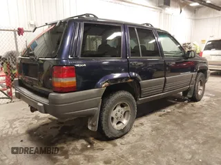 1997 Jeep Grand Cherokee Laredo with VIN 1J4GZ58S8VC675487, listed as a IAAI auction lot 41034046 with 243,284 mi miles. Bid and sale history available at carsss.com. Image 4.