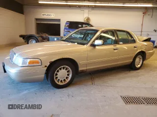 2000 Ford Crown Victoria LX z VIN 2FAFP74WXYX116130, wystawiony jako Copart lot #79441204 z przebiegiem 128 133 mil mil oraz Szkoda całkowita • Salvage title. Historia ofert i sprzedaży dostępna na DreamBid. Obrazek 1.