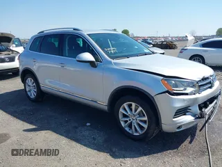 2014 Volkswagen Touareg Sport with VIN WVGEF9BP6ED007436, listed as a IAAI auction lot 41953307 with 114,925 mi miles and . Bid and sale history available at DreamBid. Image 1.