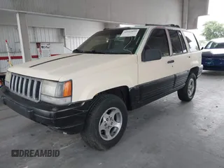 1996 Jeep Grand Cherokee Laredo z VIN 1J4FX58S7TC157272, wystawiony jako IAAI lot #42422023 z przebiegiem 229 170 mil mil oraz . Historia ofert i sprzedaży dostępna na DreamBid. Obrazek 2.