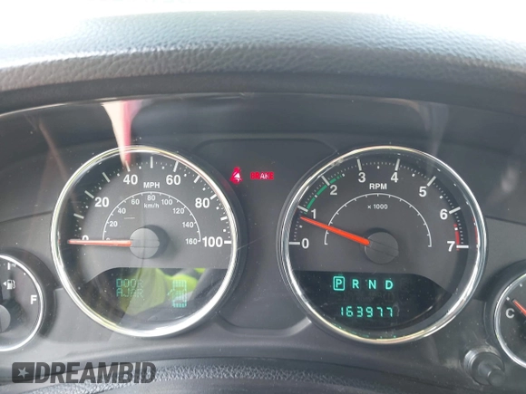 2013 Jeep Wrangler Sport z VIN 1C4GJWAG0DL543850, wystawiony jako IAAI lot #42374916 z przebiegiem 163 977 mil mil oraz . Historia ofert i sprzedaży dostępna na DreamBid. Obrazek 7.