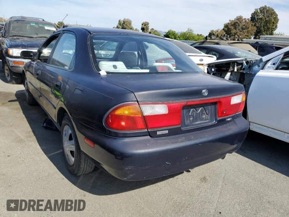 1997 Mazda Protege DX z VIN JM1BC1412V0157268, wystawiony jako Copart lot #61380564 z przebiegiem 85 356 mil mil oraz Szkoda całkowita • Salvage title. Historia ofert i sprzedaży dostępna na DreamBid. Obrazek 2.
