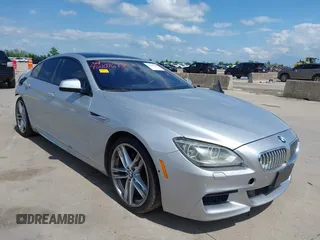 2015 BMW 6 Series 650i z VIN WBA6B2C55FGB99196, wystawiony jako IAAI lot #42107698 z przebiegiem 74 393 mil mil oraz . Historia ofert i sprzedaży dostępna na DreamBid. Obrazek 1.