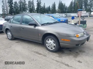 2001 Saturn SL z VIN 1G8ZH52821Z237404, wystawiony jako IAAI lot #41922228 z przebiegiem 124 853 mil mil oraz . Historia ofert i sprzedaży dostępna na DreamBid. Obrazek 1.