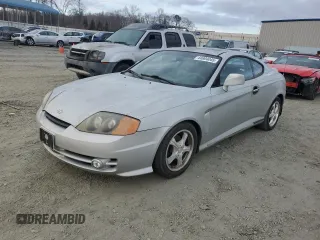 2003 Hyundai Tiburon GT z VIN KMHHN65F63U064962, wystawiony jako Copart lot #44804045 z przebiegiem 186 171 mil mil oraz Szkoda całkowita • Salvage title. Historia ofert i sprzedaży dostępna na DreamBid. Obrazek 1.