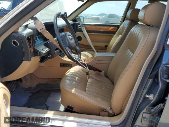 1992 Jaguar XJ with VIN SAJHY174XNC649368, listed as a Copart auction lot 50191454 with 99,553 mi miles and Salvage Title. Bid and sale history available at DreamBid. Image 7.
