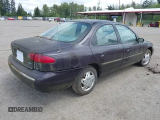 1995 Ford Contour z VIN 3FALP6633SM116313, wystawiony jako IAAI lot #42058920 z przebiegiem 192 905 mil mil oraz . Historia ofert i sprzedaży dostępna na DreamBid. Obrazek 4.