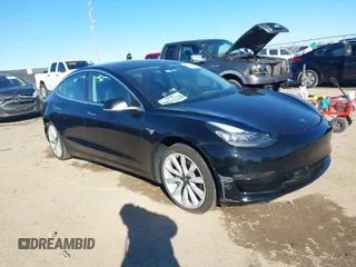 2018 Tesla Model 3 Long Range Battery with VIN 5YJ3E1EA2JF014975, listed as a IAAI auction lot 41319407 with 106,301 mi miles. Bid and sale history available at carsss.com. Image 1.