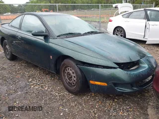 1997 Saturn SC z VIN 1G8ZG1277VZ342397, wystawiony jako IAAI lot #41966570 z przebiegiem 184 054 mil mil oraz . Historia ofert i sprzedaży dostępna na DreamBid. Obrazek 1.