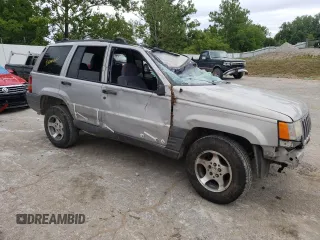1996 Jeep Grand Cherokee Laredo with VIN 1J4GZ58S2TC401845, listed as a Copart auction lot 61013044 with 0 mi miles and Salvage Title. Bid and sale history available at carsss.com. Image 4.