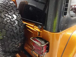 1998 Jeep Wrangler Sahara z VIN 1J4FY49S1WP802940, wystawiony jako IAAI lot #41433820 z przebiegiem 122 180 mil mil oraz . Historia ofert i sprzedaży dostępna na DreamBid. Obrazek 12.