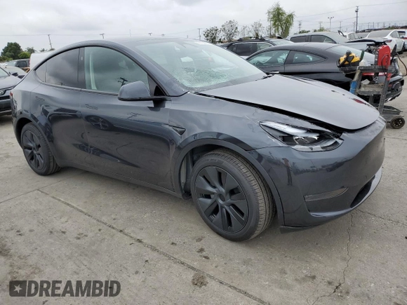 2025 Tesla Model Y Long Range with VIN 7SAYGDED4SF242721, listed as a Copart auction lot 56159955 with 7,131 mi miles and Salvage Title. Bid and sale history available at DreamBid. Image 4.