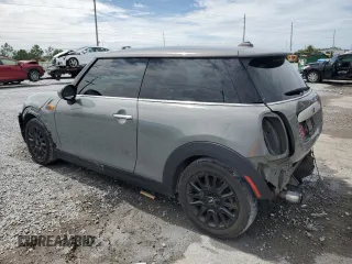 2014 MINI Hardtop with VIN WMWXM5C51ET934047, listed as a Copart auction lot 63039335 with 104,446 mi miles and Salvage title. Bid and sale history available at DreamBid. Image 2.