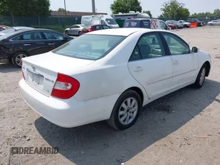 2002 Toyota Camry XLE z VIN 4T1BF30K22U007310, wystawiony jako IAAI lot #42419765 z przebiegiem 206 050 mil mil oraz . Historia ofert i sprzedaży dostępna na DreamBid. Obrazek 4.