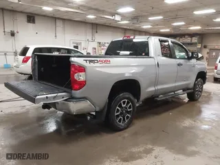 2014 Toyota Tundra 4WD Truck SR with VIN 5TFUY5F17EX357035, listed as a IAAI auction lot 39928076 with 129,831 mi miles. Bid and sale history available at carsss.com. Image 4.