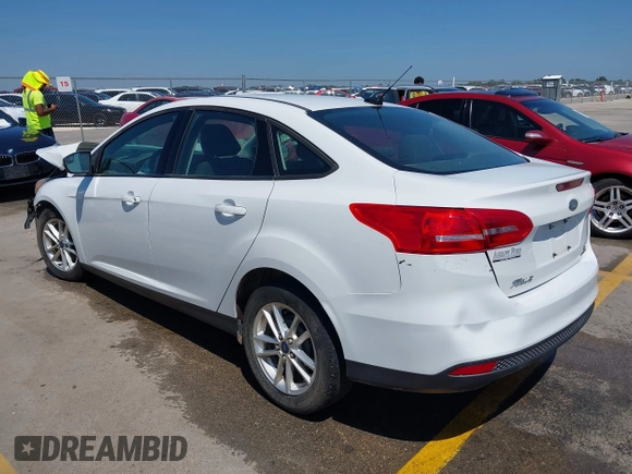 2016 Ford Focus SE z VIN 1FADP3F23GL338496, wystawiony jako IAAI lot #42333608 z przebiegiem 76 972 mil mil oraz . Historia ofert i sprzedaży dostępna na DreamBid. Obrazek 3.