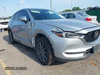 2020 Mazda CX-5 Grand Touring with VIN JM3KFADM5L0739306, listed as a IAAI auction lot 42215667 with 126,100 mi miles and . Bid and sale history available at DreamBid. Image 1.