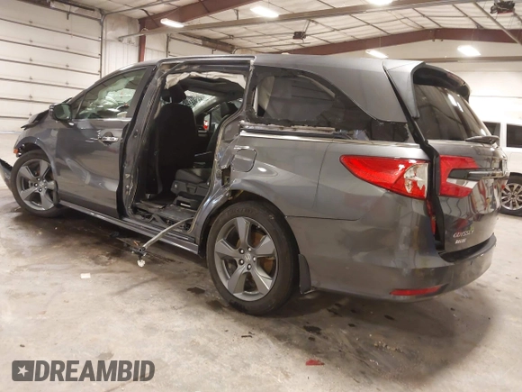 2021 Honda Odyssey Touring with VIN 5FNRL6H82MB025923, listed as a IAAI auction lot 42104290 with 61,178 mi miles and . Bid and sale history available at DreamBid. Image 3.