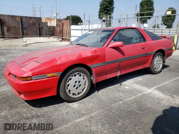 1989 Toyota Supra z VIN JT2MA70J3K0114537, wystawiony jako Copart lot #72587854 z przebiegiem 189 813 mil mil oraz Czysty tytuł • Clean title. Historia ofert i sprzedaży dostępna na DreamBid. Obrazek 1.
