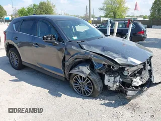 2021 Mazda CX-5 Touring z VIN JM3KFBCM0M1307709, wystawiony jako IAAI lot #42277653 z przebiegiem 37 697 mil mil oraz . Historia ofert i sprzedaży dostępna na DreamBid. Obrazek 1.