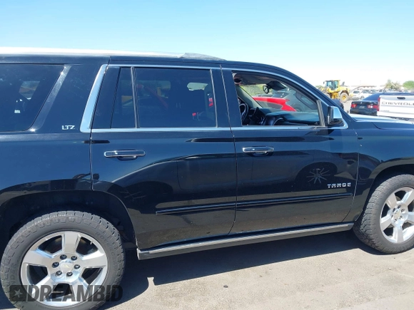 2015 Chevrolet Tahoe LTZ z VIN 1GNSKCKC7FR715512, wystawiony jako IAAI lot #42054583 z przebiegiem 106 941 mil mil oraz . Historia ofert i sprzedaży dostępna na DreamBid. Obrazek 13.