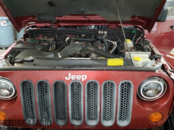 2007 Jeep Wrangler Unlimited Sahara with VIN 1J4GA59197L104784, listed as a Copart auction lot 56700205 with 156,382 mi miles and Salvage title. Bid and sale history available at DreamBid. Image 12.