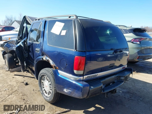 1999 GMC Jimmy SLE with VIN 1GKDT13W3X2553792, listed as a IAAI auction lot 41876489 with 266,884 mi miles. Bid and sale history available at carsss.com. Image 3.