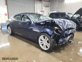 2014 Jaguar XJ with VIN SAJWJ2GD5E8V69562, listed as a Copart auction lot 87737195 with 100,525 mi miles and Salvage Title. Bid and sale history available at carsss.com. Image 4.
