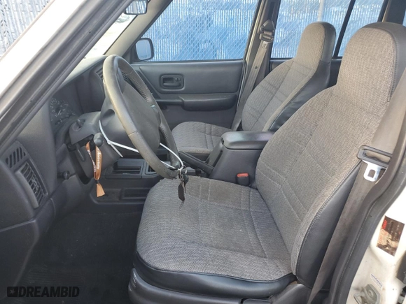1999 Jeep Cherokee Sport with VIN 1J4FT68S6XL578679, listed as a Copart auction lot 76697394 with 196,110 mi miles and Salvage Title. Bid and sale history available at carsss.com. Image 7.