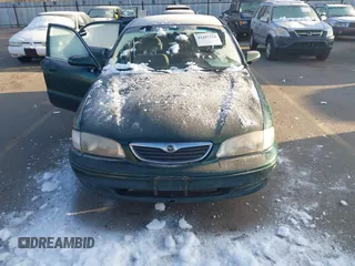 1998 Mazda 626 DX with VIN 1YVGF22C9W5721679, listed as a IAAI auction lot 41287224 with 134,384 mi miles. Bid and sale history available at carsss.com. Image 6.